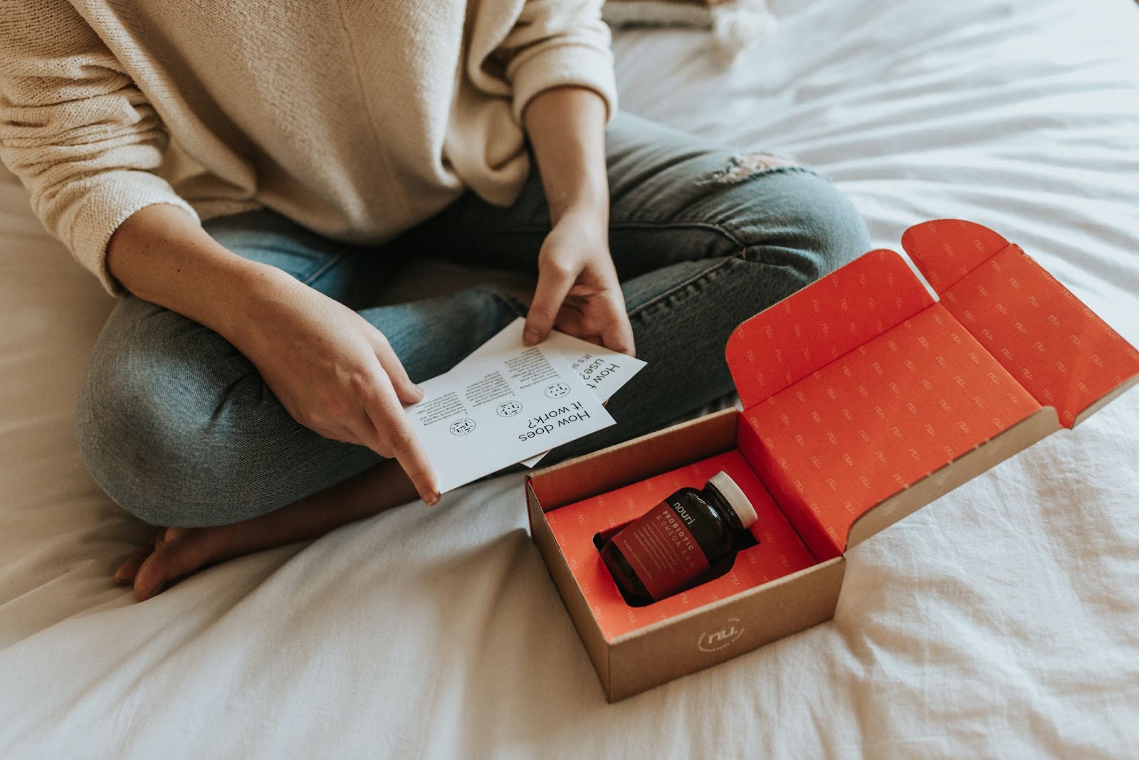 e-commerce buyer unboxing an online purchase that has arrived in custom packaging
